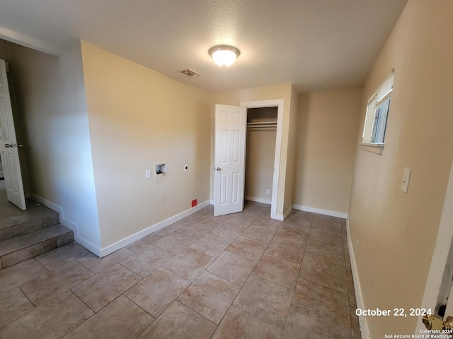 unfurnished bedroom with a closet, visible vents, and baseboards