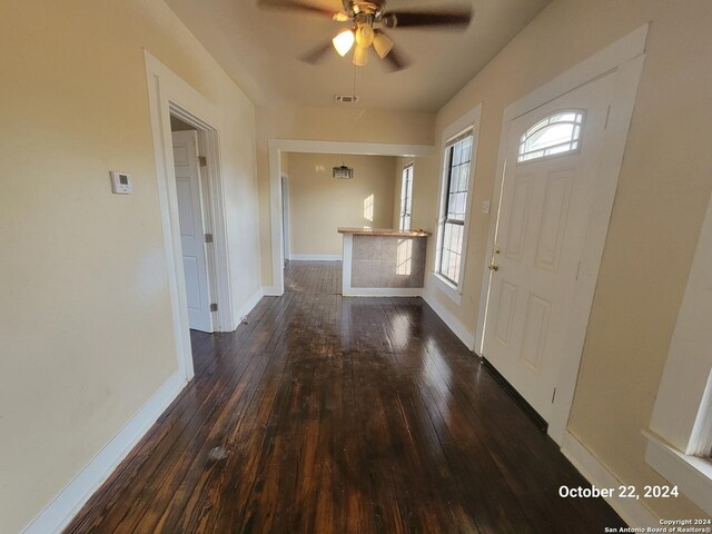 entryway with baseboards, a ceiling fan, hardwood / wood-style floors, and visible vents