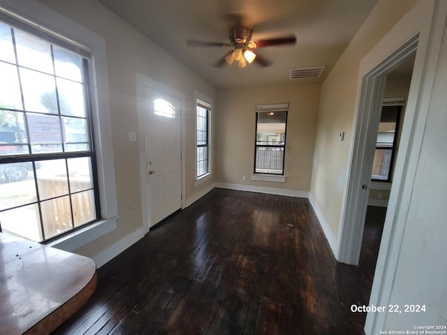 entrance foyer featuring hardwood / wood-style flooring, ceiling fan, baseboards, and visible vents