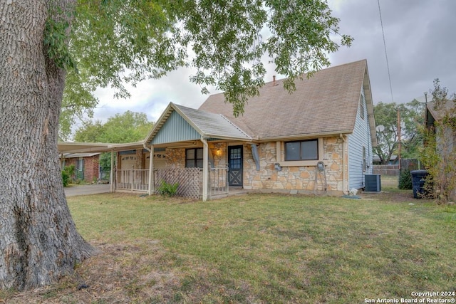 view of front facade featuring covered porch, a front lawn, and central air condition unit