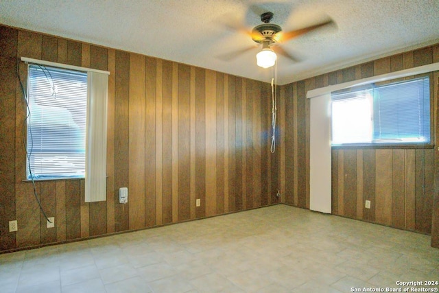 spare room with ceiling fan and a textured ceiling