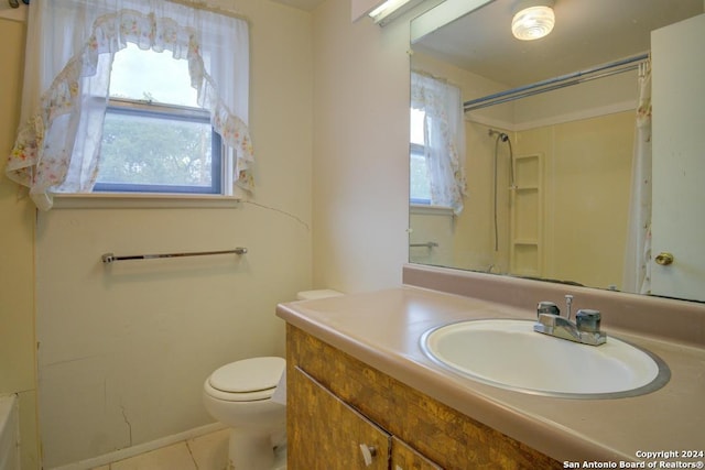 bathroom with vanity, tile patterned flooring, toilet, and a wealth of natural light