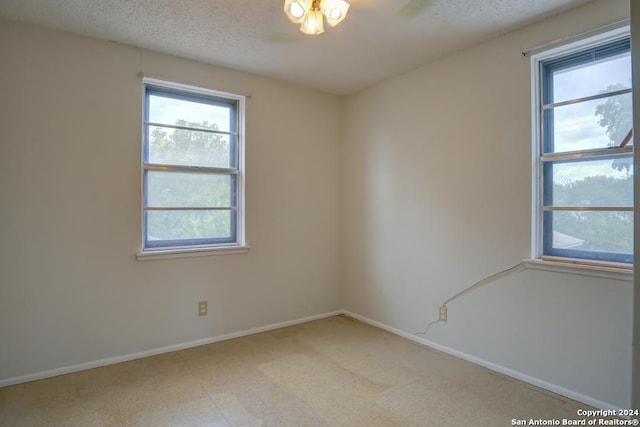 empty room featuring a textured ceiling