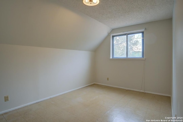 bonus room featuring a textured ceiling and lofted ceiling