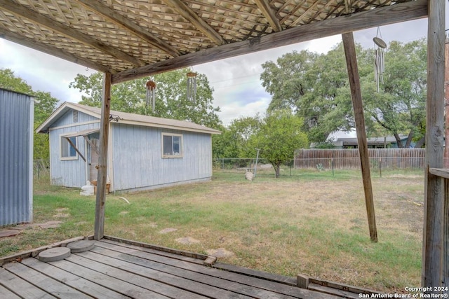 view of yard with a deck and a shed