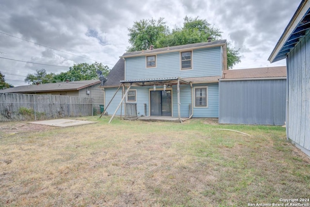 back of house with a yard