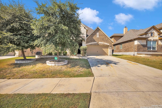 view of front of property featuring a front yard and a garage