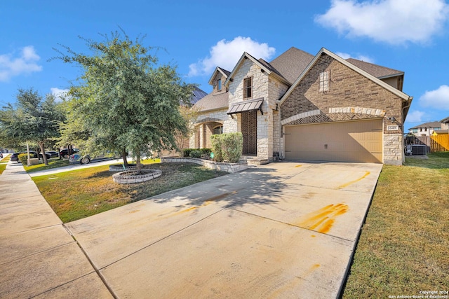 view of front of home featuring a front yard and a garage