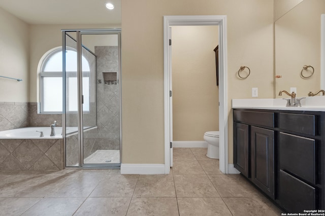 full bathroom featuring vanity, toilet, tile patterned flooring, and plus walk in shower