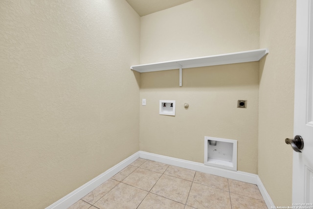 washroom featuring gas dryer hookup, light tile patterned flooring, washer hookup, and electric dryer hookup