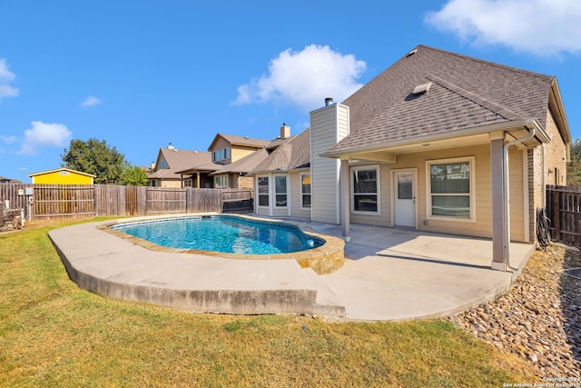 view of pool featuring a patio and a yard