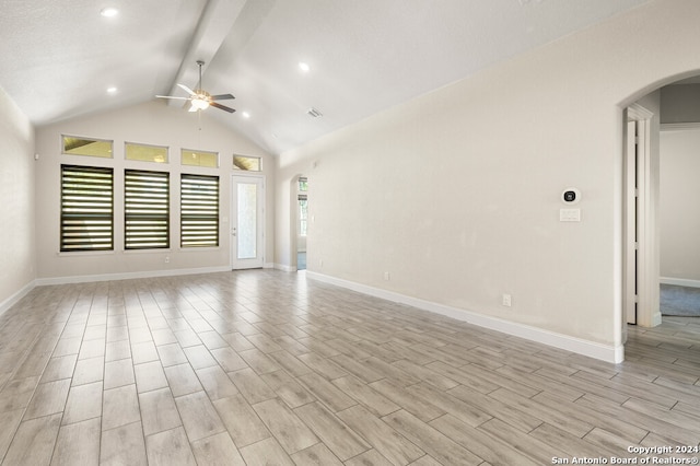 empty room with vaulted ceiling with beams, light wood-type flooring, and ceiling fan