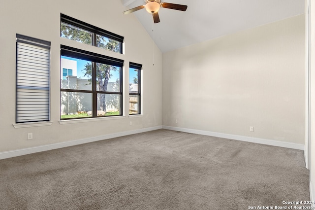 spare room featuring light colored carpet, high vaulted ceiling, and ceiling fan