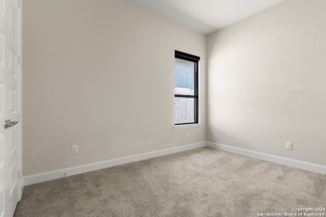 unfurnished room featuring light colored carpet