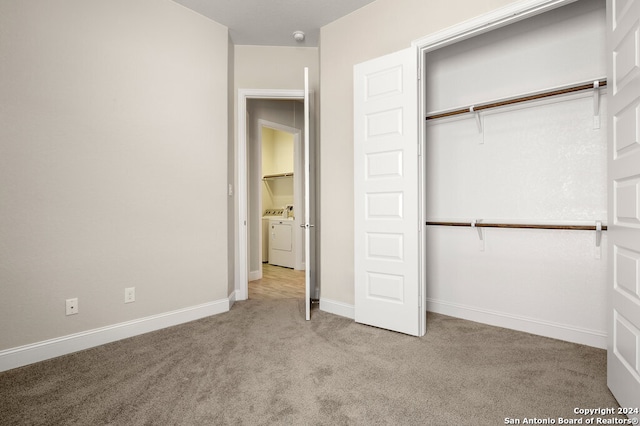 unfurnished bedroom featuring light colored carpet and a closet