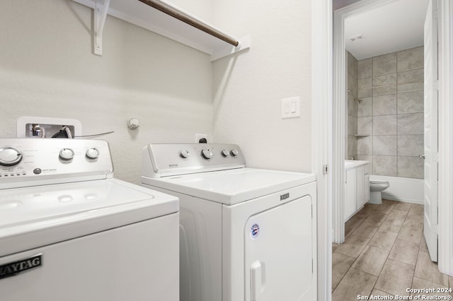 clothes washing area featuring separate washer and dryer