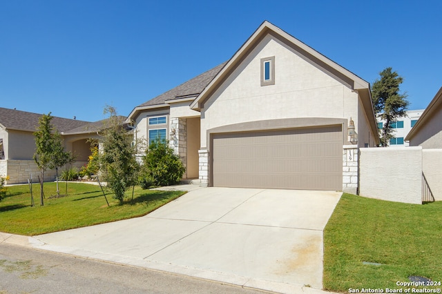 view of front of home featuring a front yard and a garage