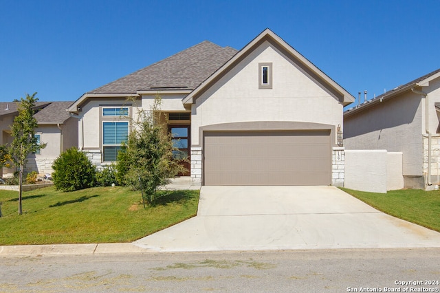 view of front of house with a garage and a front lawn