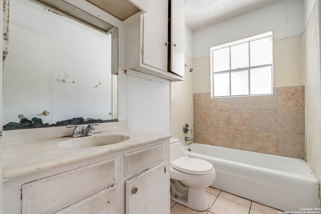 full bathroom featuring a textured ceiling, toilet, tile patterned floors, vanity, and tiled shower / bath combo