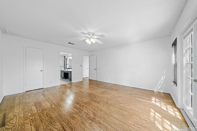 unfurnished living room with hardwood / wood-style floors, ceiling fan, and a textured ceiling