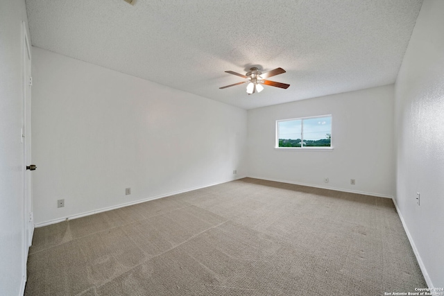 unfurnished room featuring a textured ceiling, carpet flooring, and ceiling fan