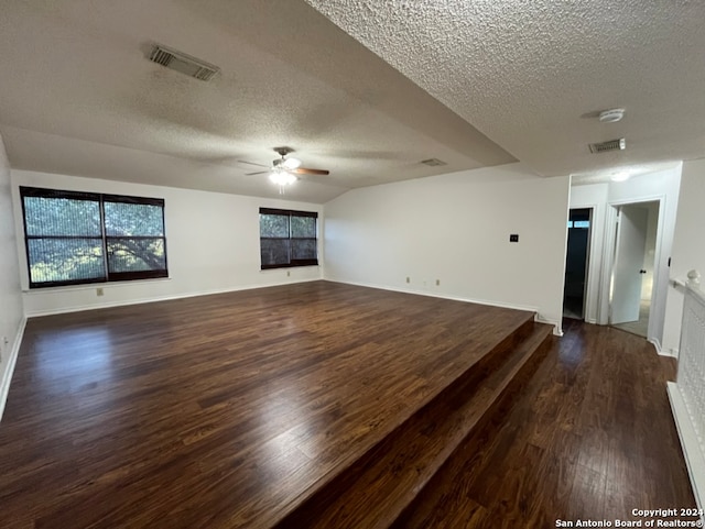 spare room with a textured ceiling, dark hardwood / wood-style floors, and ceiling fan