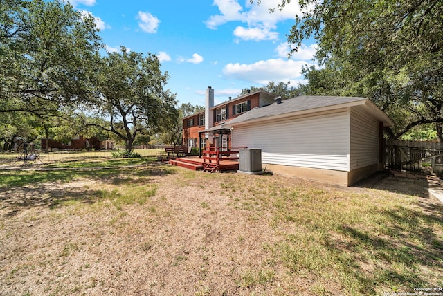 view of yard featuring central AC and a deck