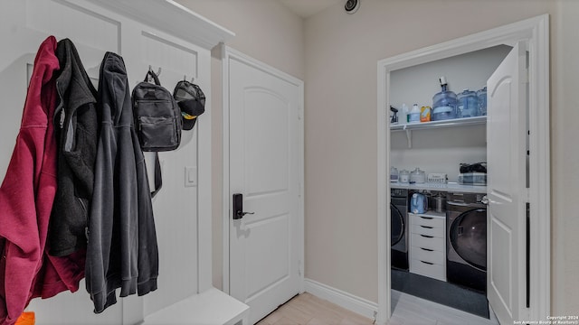 mudroom featuring washer and clothes dryer and light hardwood / wood-style floors