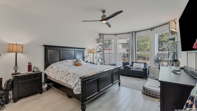 bedroom with ceiling fan and light wood-type flooring