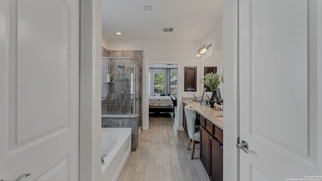 bathroom featuring vanity and shower with separate bathtub