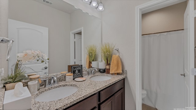 bathroom featuring vanity, a shower with shower curtain, and toilet