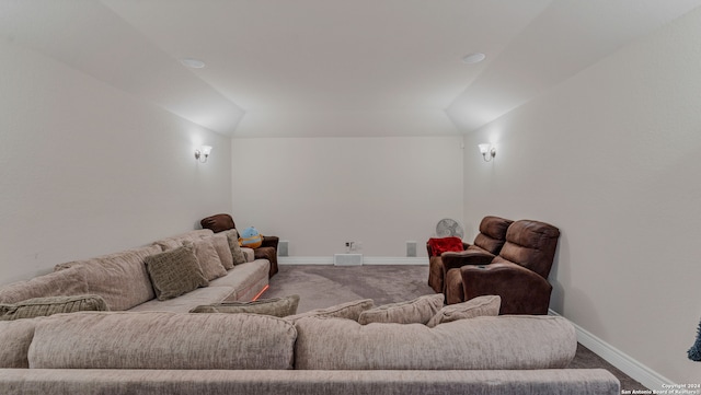 carpeted home theater room with lofted ceiling