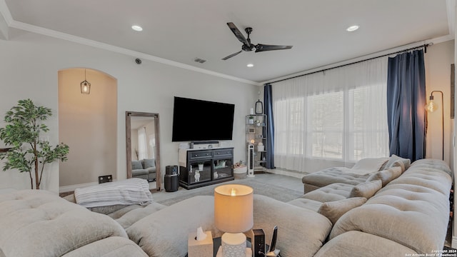 living room featuring ornamental molding and ceiling fan