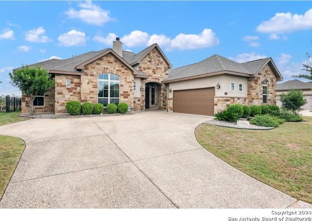 view of front of home with a front yard and a garage