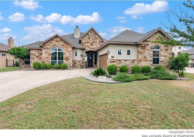 view of front of house with a front lawn and a garage