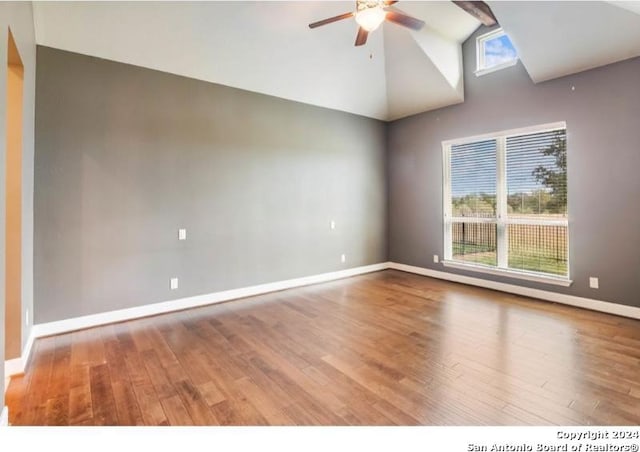 spare room with hardwood / wood-style floors, ceiling fan, and vaulted ceiling