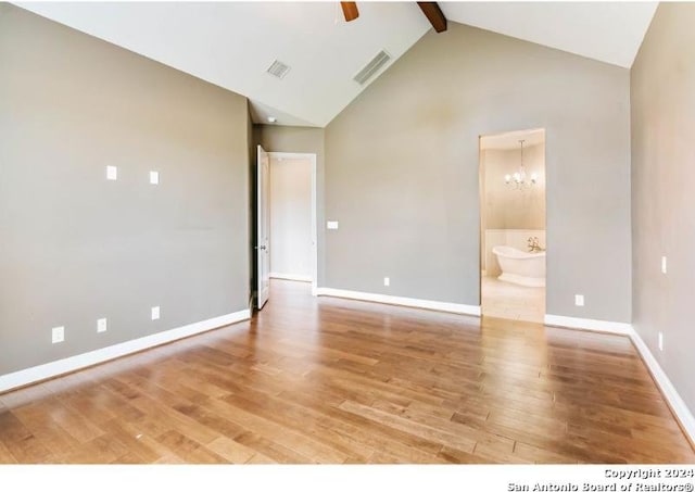 unfurnished room with beam ceiling, light hardwood / wood-style flooring, high vaulted ceiling, and ceiling fan with notable chandelier