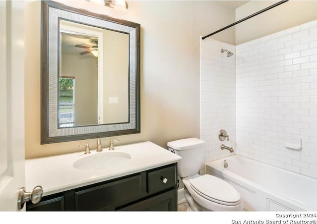 full bathroom with toilet, tiled shower / bath, and vanity