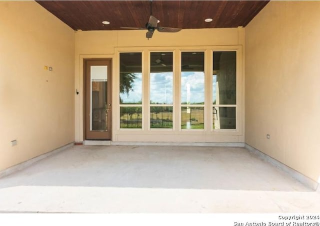 entrance to property with a patio and ceiling fan