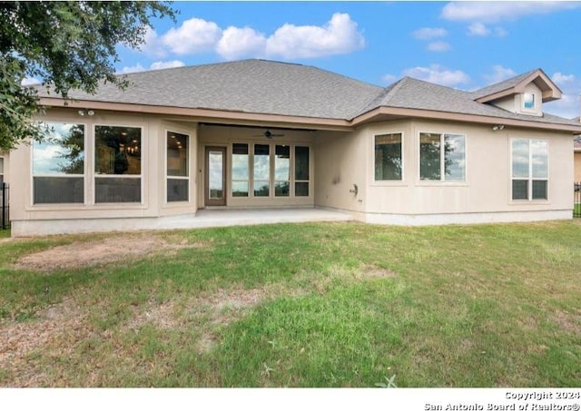 back of property featuring a patio, a yard, and ceiling fan