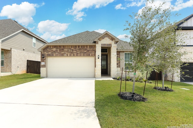 view of front facade with a front yard and a garage