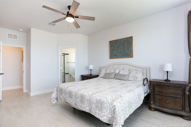 bedroom with light hardwood / wood-style floors, ensuite bath, and ceiling fan