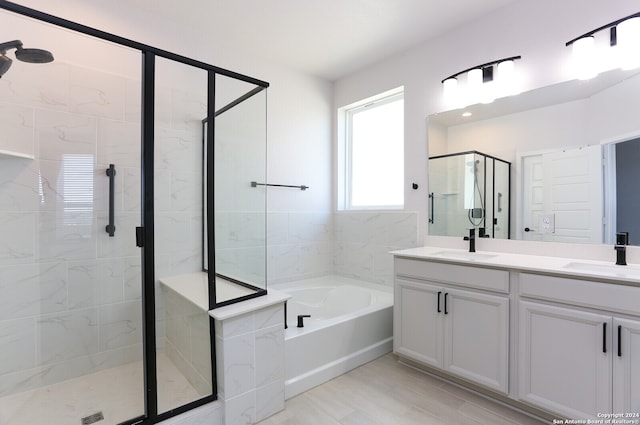 bathroom with vanity and separate shower and tub