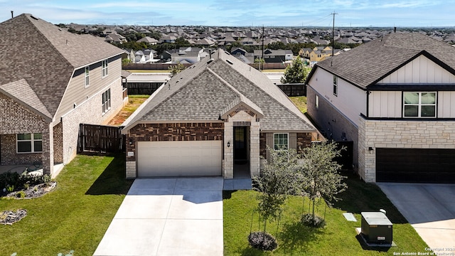 view of front of property with a front yard and a garage