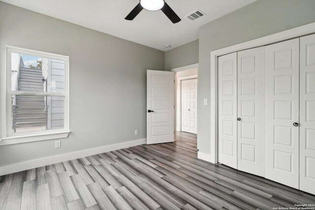159 E Davis Ct Unit 102, San Antonio, TX 78209 - unfurnished bedroom with baseboards, a closet, wood finished floors, and visible vents