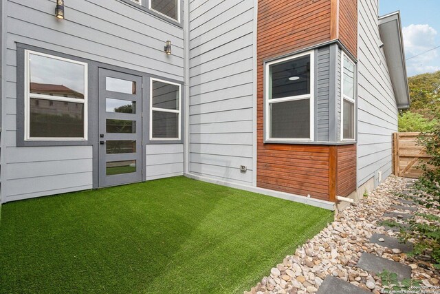 159 E Davis Ct Unit 102, San Antonio, TX 78209 - view of exterior entry with a lawn
