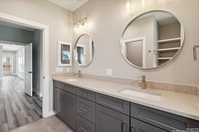159 E Davis Ct Unit 102, San Antonio, TX 78209 - full bath featuring double vanity, a sink, baseboards, and tile patterned floors