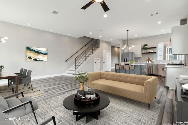159 E Davis Ct Unit 102, San Antonio, TX 78209 - living area with a ceiling fan, recessed lighting, wood finished floors, visible vents, and stairway