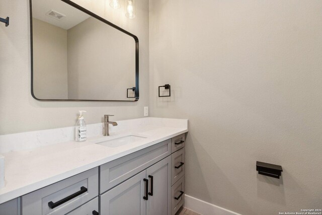 159 E Davis Ct Unit 102, San Antonio, TX 78209 - bathroom featuring baseboards, visible vents, and vanity