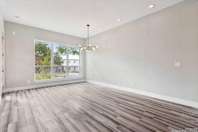 interior space featuring light hardwood / wood-style flooring and a chandelier